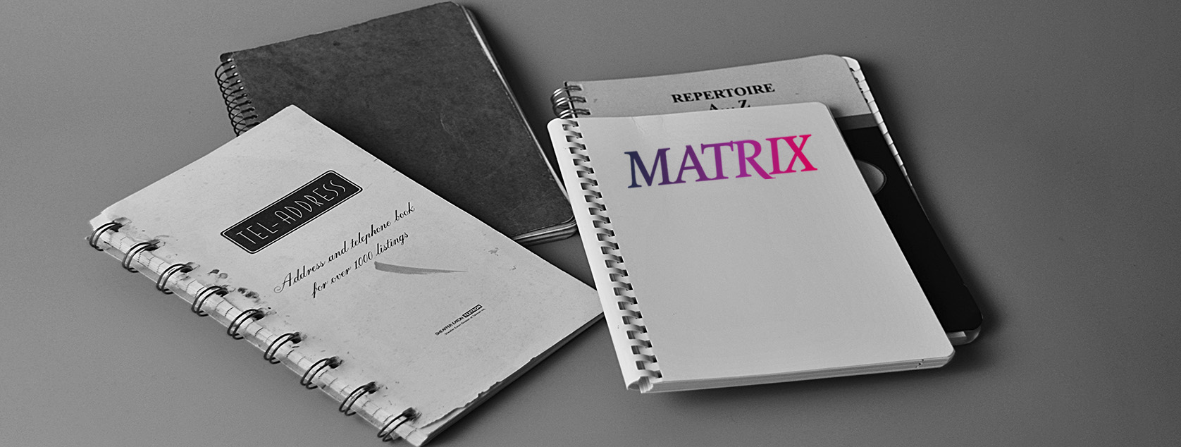 Black and white image of a spiral notepad, repertoire, and address book with the words MATRIX on the cover used for the PEOPLE search page