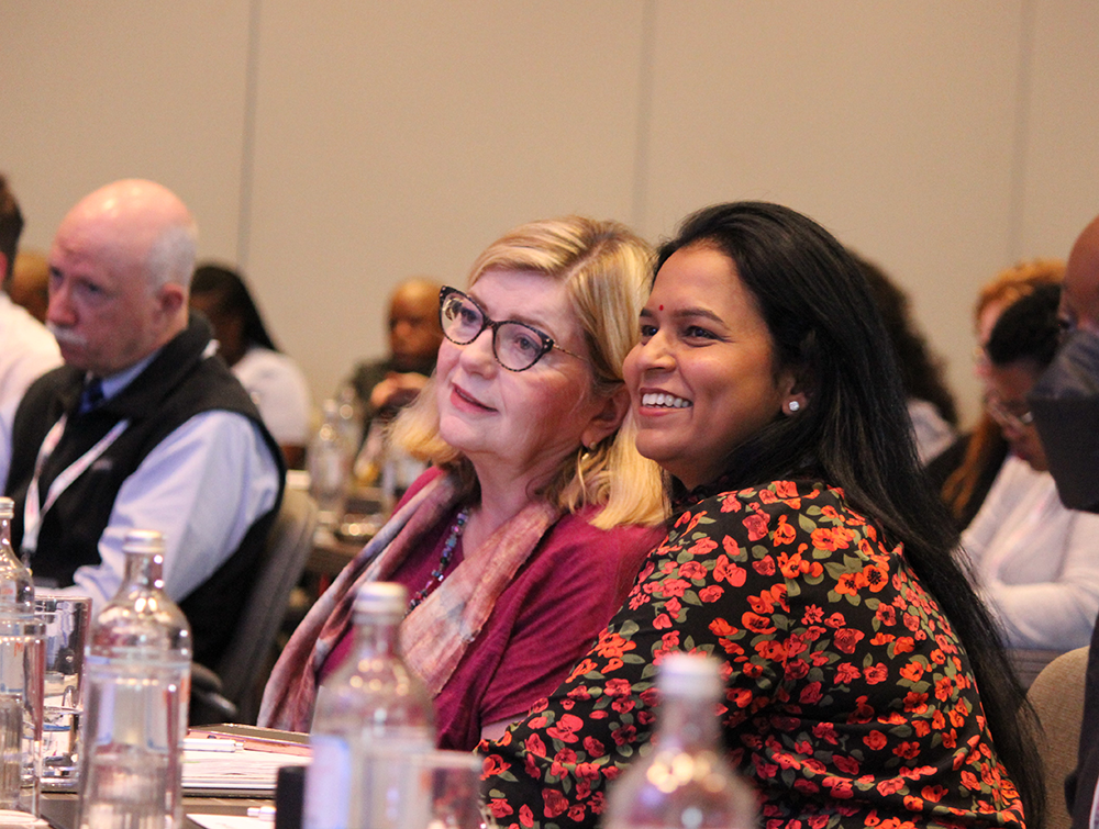 Audience members watching a presentation