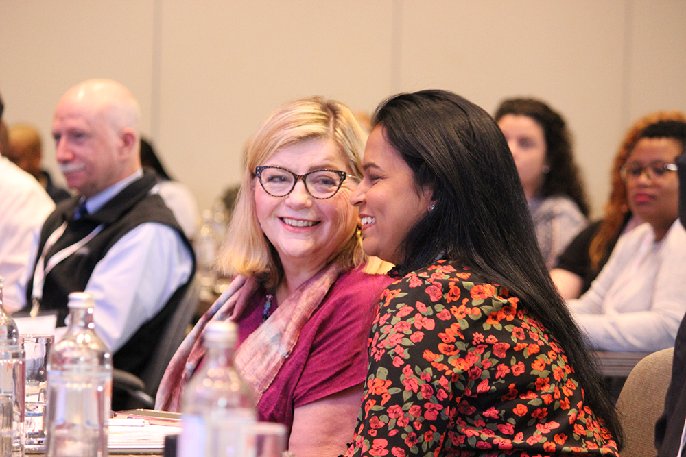 Audience members watching a presentation