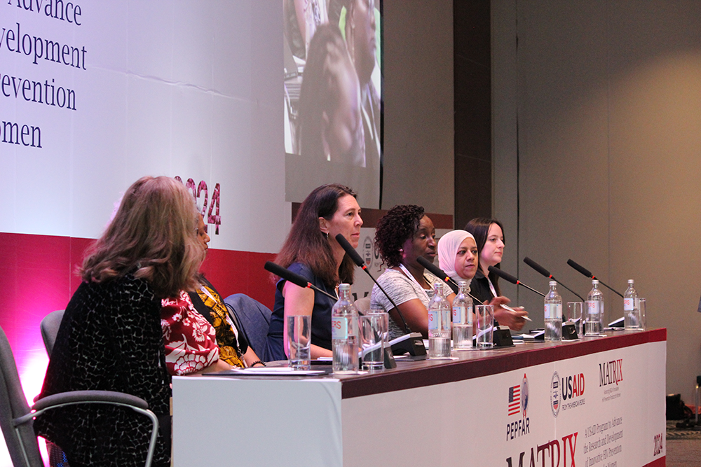 Panelists listening to a presentation