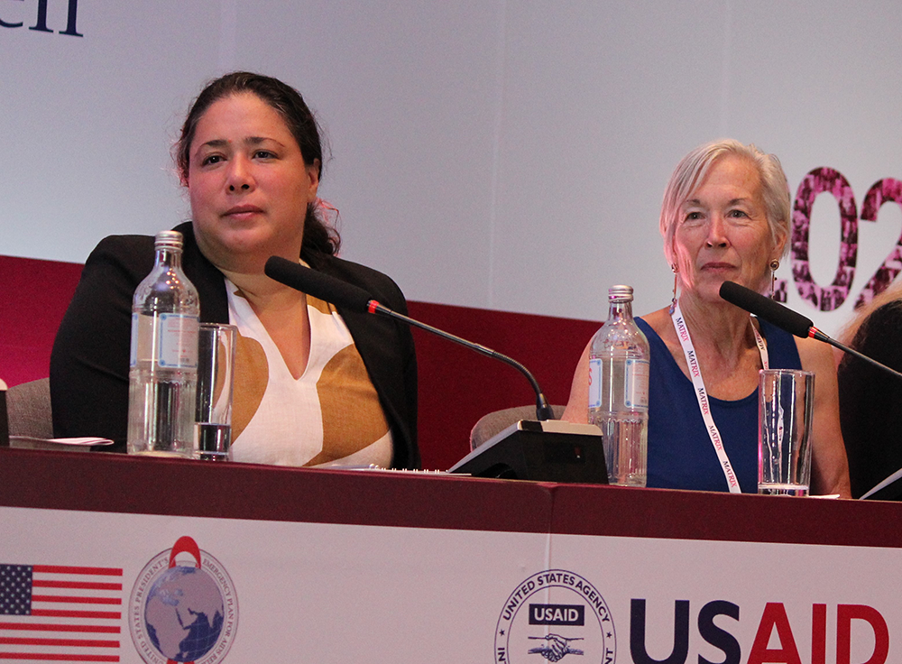 Panelists listening to a presentation