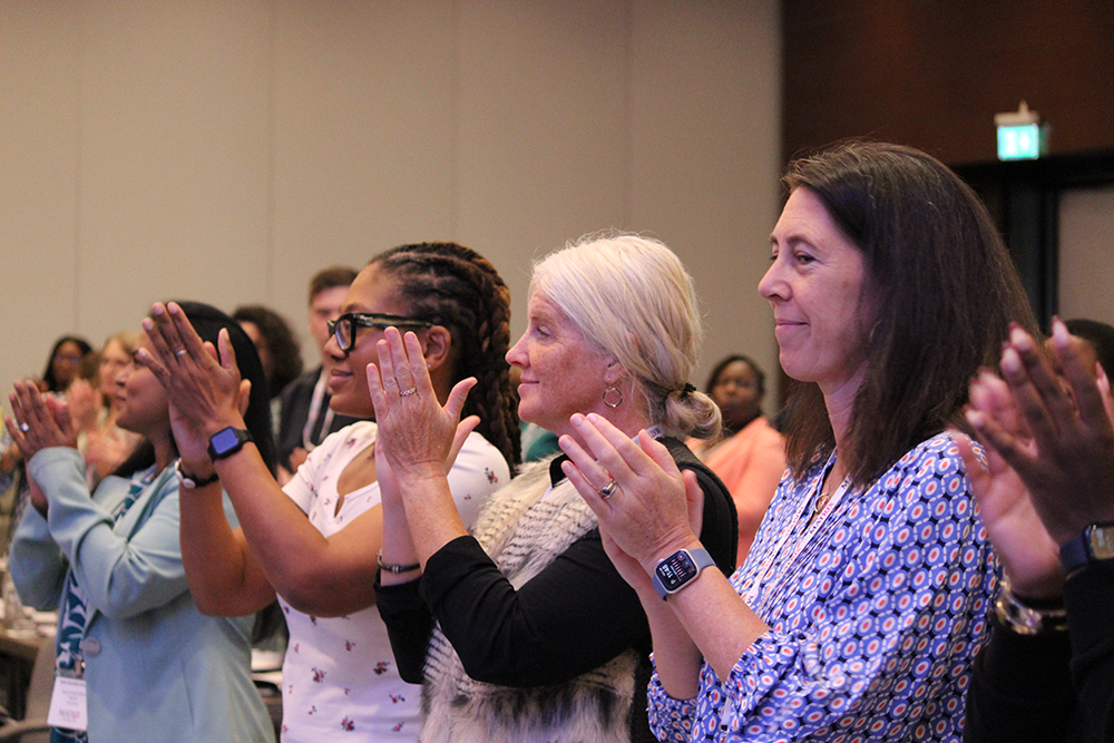 A group clapping during a meeting