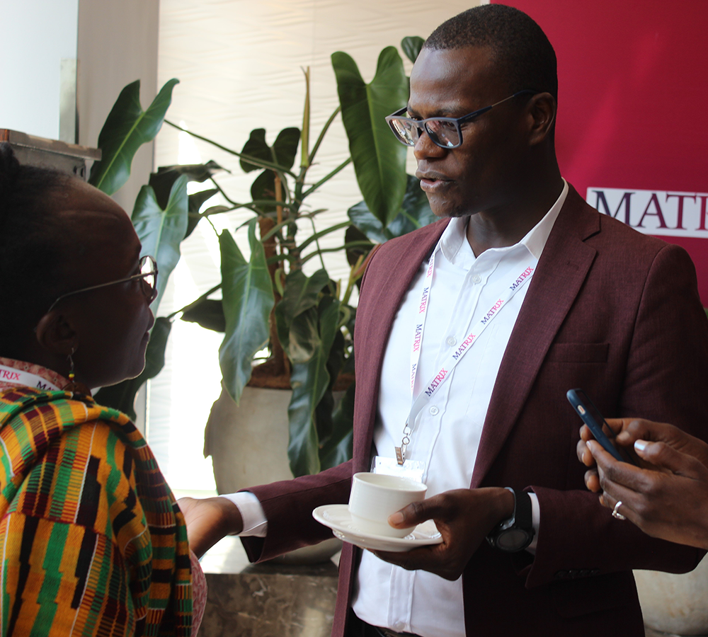 People conversing during a tea break