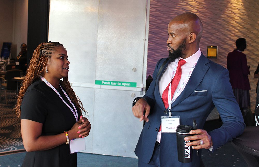 Two people conversing during a tea break